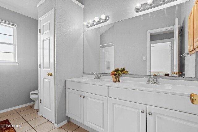 bathroom featuring walk in shower, vanity, toilet, and tile patterned floors