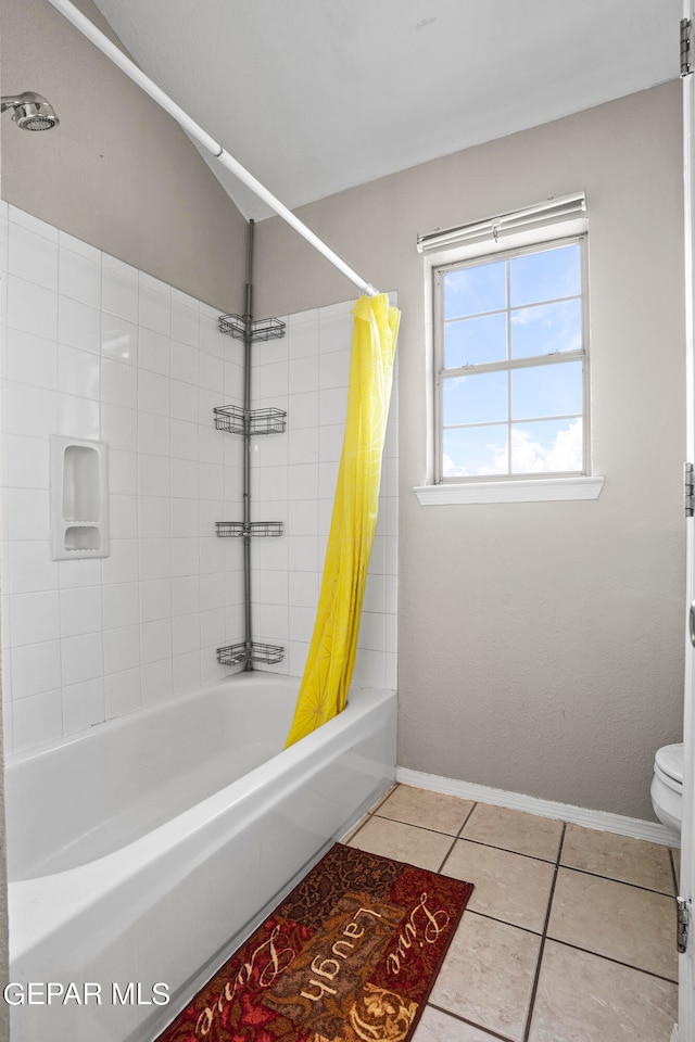 bathroom with tile patterned floors, shower / tub combo with curtain, and toilet