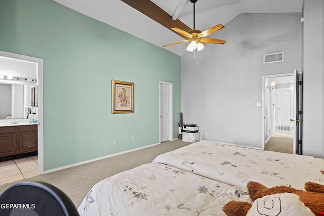 carpeted bedroom with ceiling fan, high vaulted ceiling, and ensuite bath