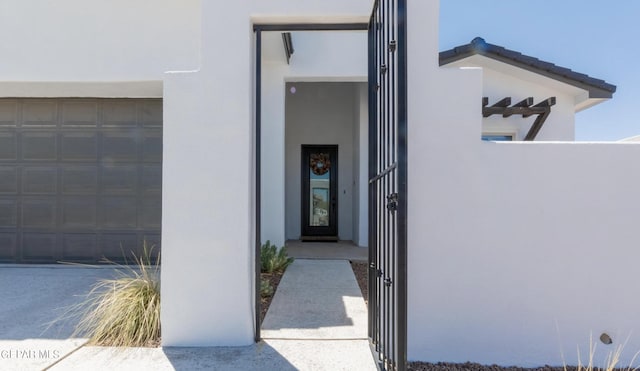 doorway to property with a garage