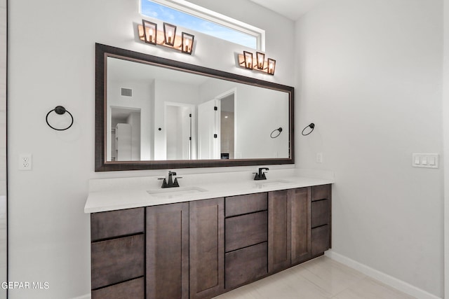 bathroom with tile patterned flooring and vanity