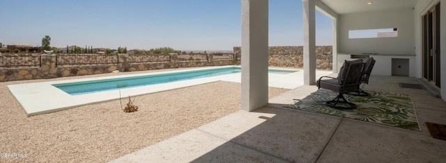 view of swimming pool with a patio