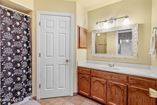 bathroom featuring tile patterned flooring and vanity