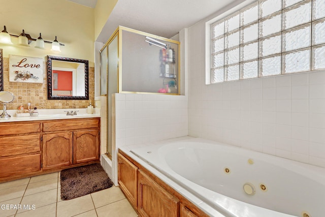 bathroom with tile patterned floors, vanity, and independent shower and bath