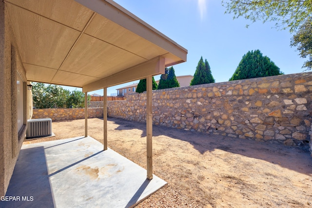 view of yard with cooling unit and a patio area