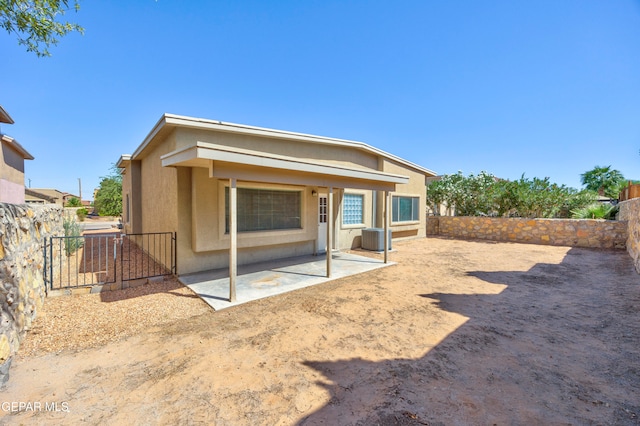 back of property with a patio and central air condition unit