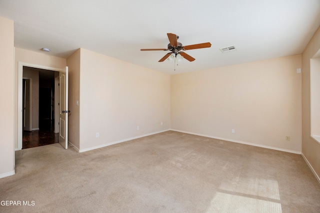 spare room featuring ceiling fan and light colored carpet