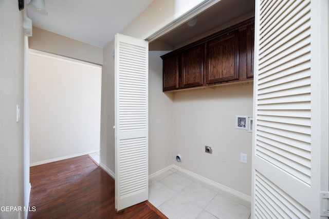 washroom featuring hookup for a washing machine, cabinets, light wood-type flooring, and electric dryer hookup