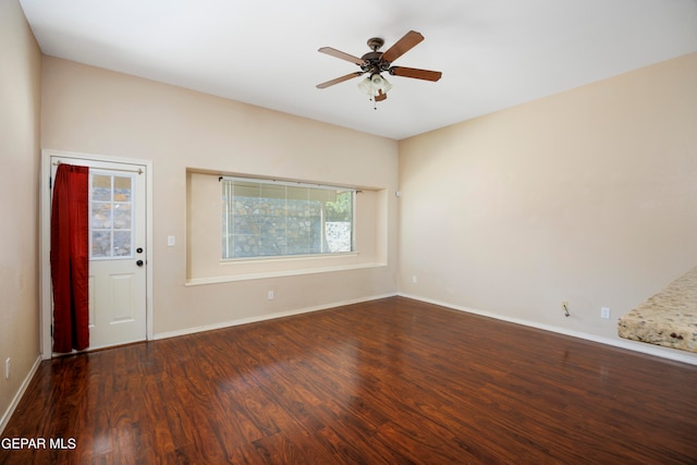 unfurnished room with ceiling fan and dark hardwood / wood-style floors