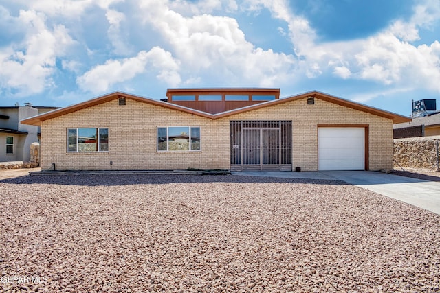 ranch-style house featuring a garage and a sunroom