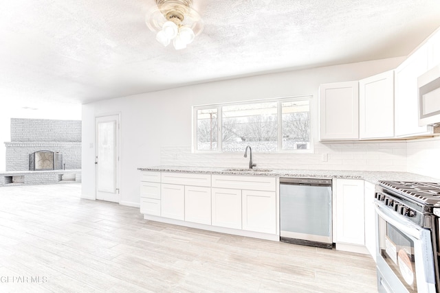 kitchen featuring white cabinets, dishwasher, and sink