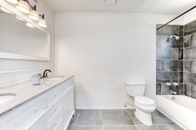 full bathroom with tiled shower / bath, vanity, tile patterned flooring, and toilet