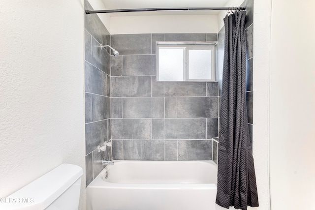 bathroom with shower / bathtub combination with curtain and toilet