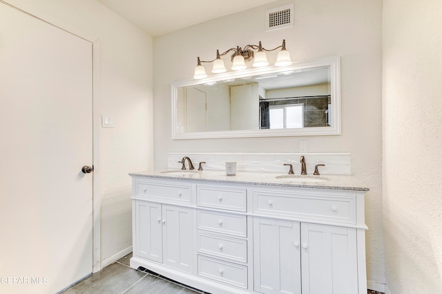 bathroom with tile patterned floors and vanity