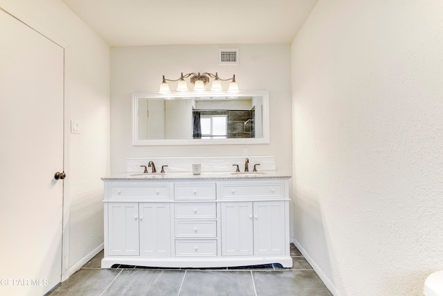 bathroom featuring tile patterned flooring and vanity