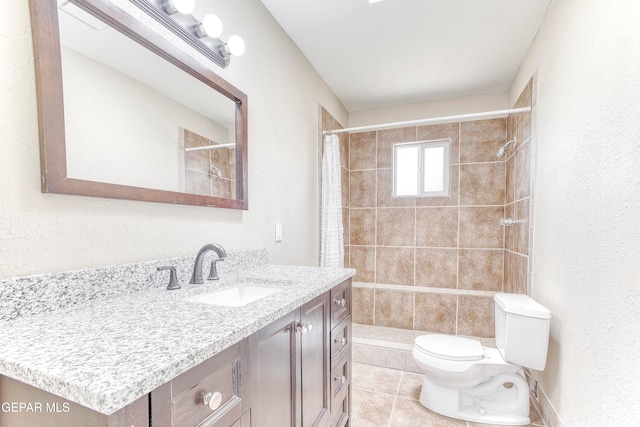 bathroom with tile patterned floors, vanity, toilet, and curtained shower