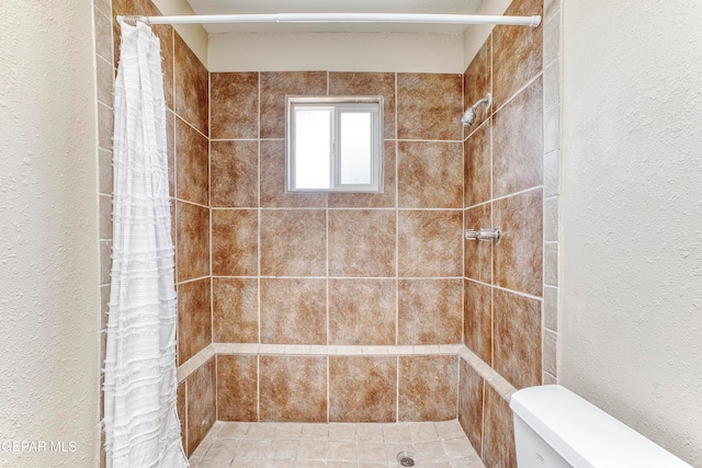 bathroom with a shower with curtain and toilet