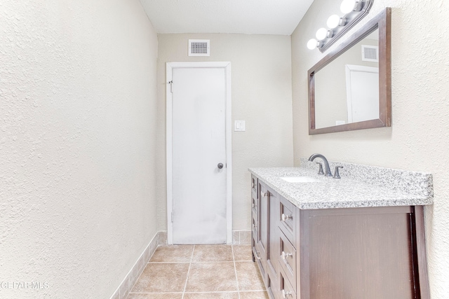 bathroom with tile patterned flooring and vanity