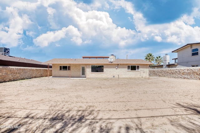 rear view of house with central AC unit