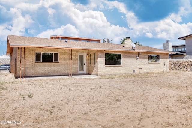 back of property with a patio