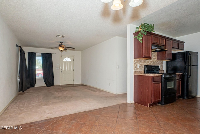 kitchen featuring carpet floors, ceiling fan, black appliances, and a textured ceiling