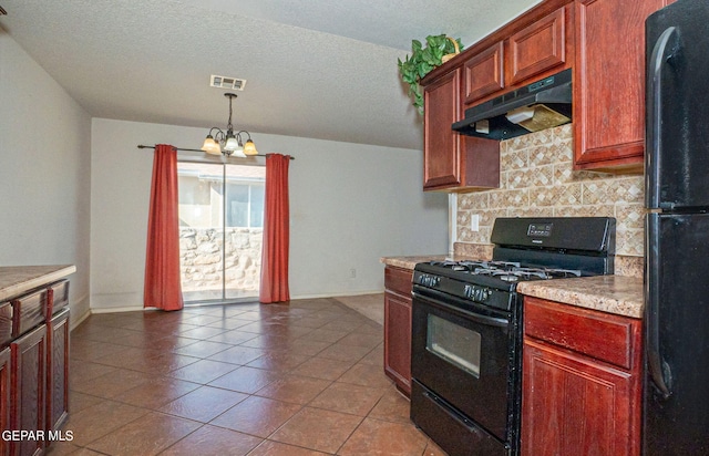 kitchen featuring a textured ceiling, decorative light fixtures, black appliances, a notable chandelier, and tile patterned flooring