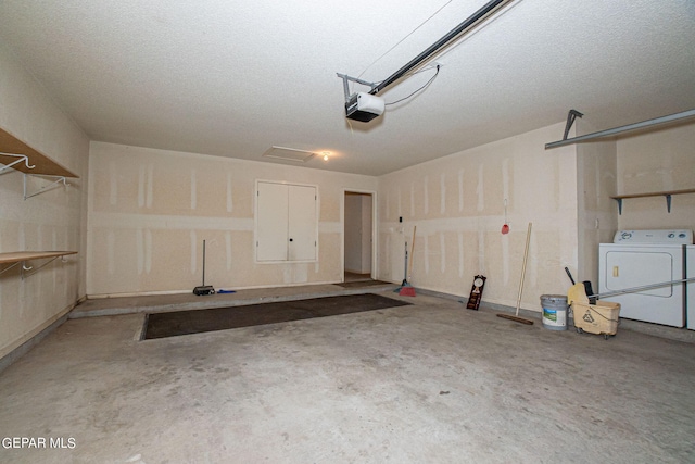 garage featuring a garage door opener and washer and dryer