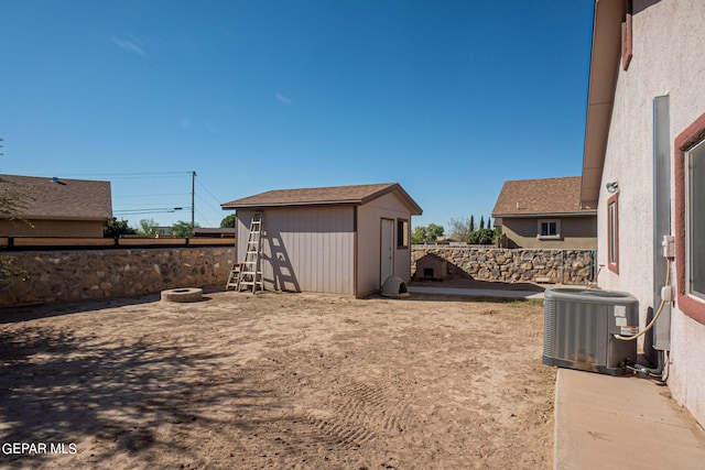 view of yard with a storage unit and central air condition unit