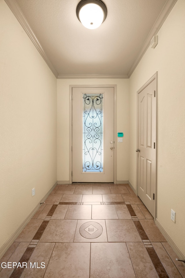 entryway with light tile patterned flooring, ornamental molding, and a textured ceiling