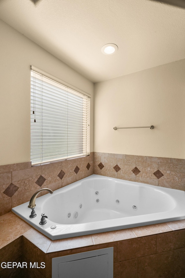 bathroom featuring a relaxing tiled tub