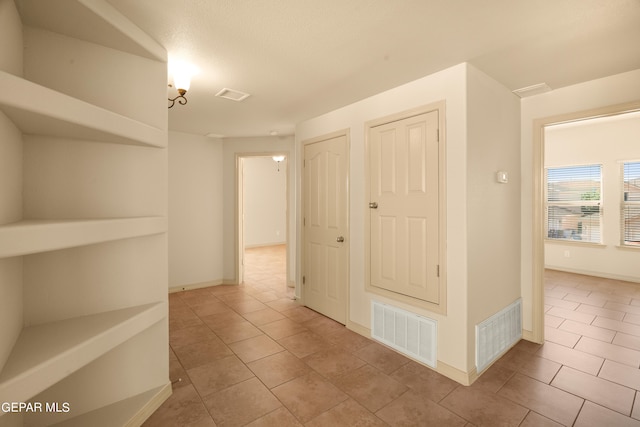 corridor with light tile patterned flooring