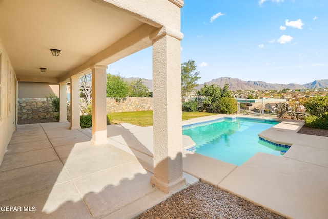 view of swimming pool featuring a mountain view and a patio area