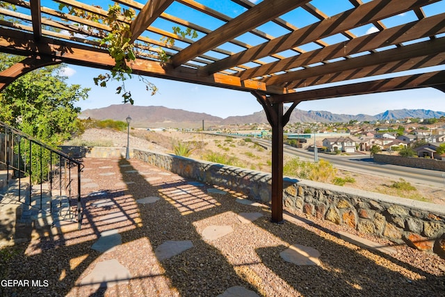 view of patio / terrace featuring a pergola and a mountain view