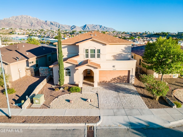 view of front facade with a garage and a mountain view