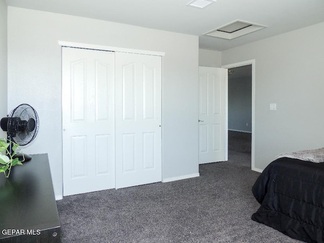 bedroom with a closet and dark colored carpet