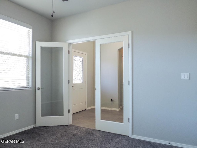 interior space featuring french doors and dark carpet