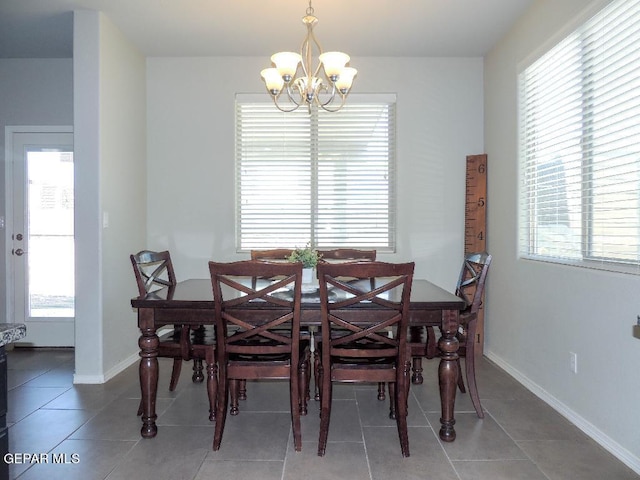 dining space featuring tile patterned flooring, an inviting chandelier, and plenty of natural light