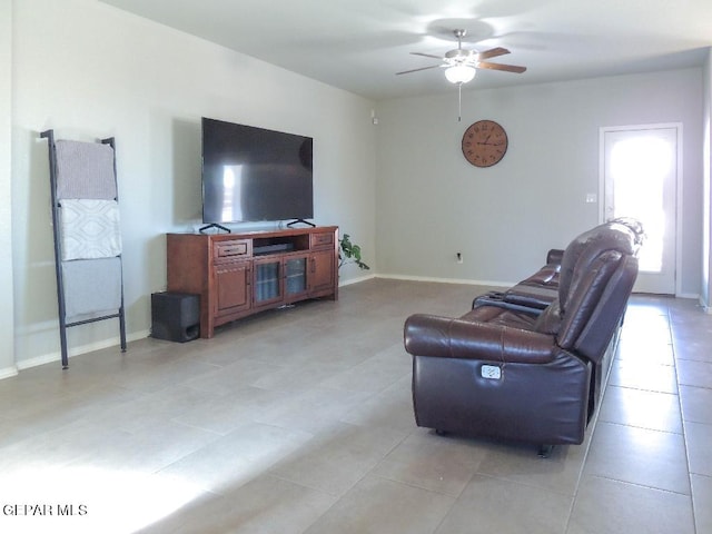 living room featuring light tile patterned floors and ceiling fan