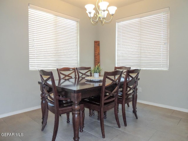 dining space featuring a chandelier and light tile patterned floors