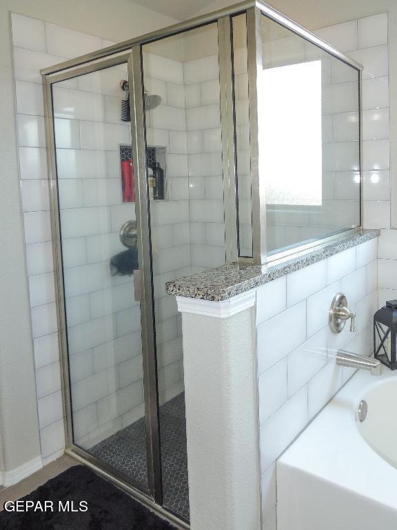 bathroom with separate shower and tub