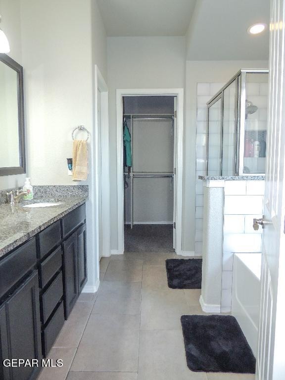 bathroom featuring vanity, tile patterned floors, and an enclosed shower