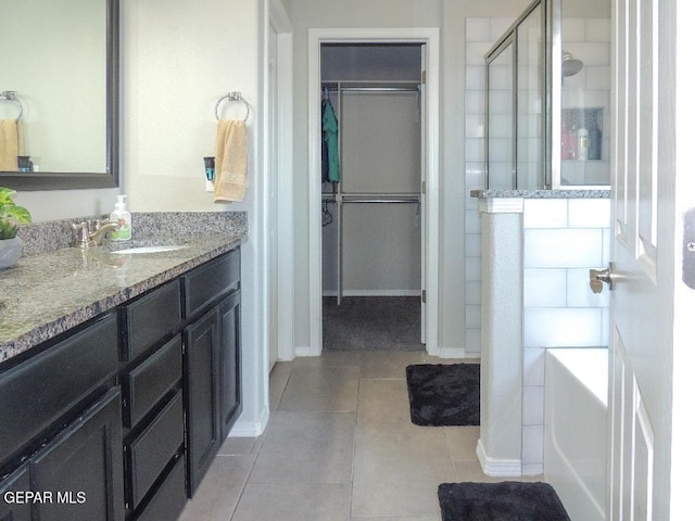 bathroom featuring vanity, tile patterned flooring, and a shower with door