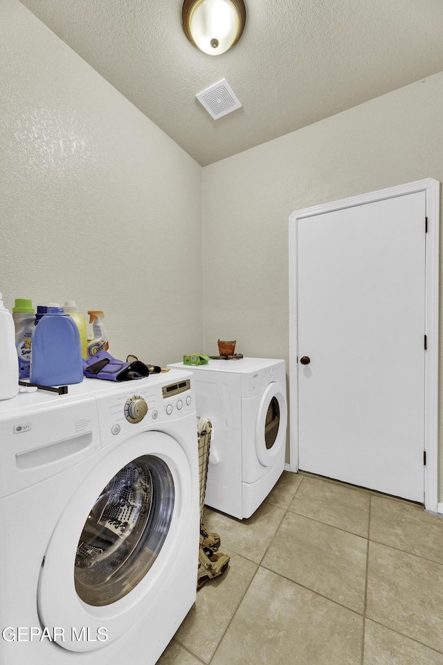 14241 Craggy Rock Ave, El Paso, TX 79938 - clothes washing area with separate washer and dryer, laundry area, light tile patterned floors, visible vents, and a textured ceiling