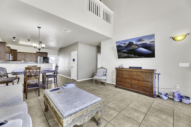 14241 Craggy Rock Ave, El Paso, TX 79938 - living room with light tile patterned floors, visible vents, a notable chandelier, and baseboards
