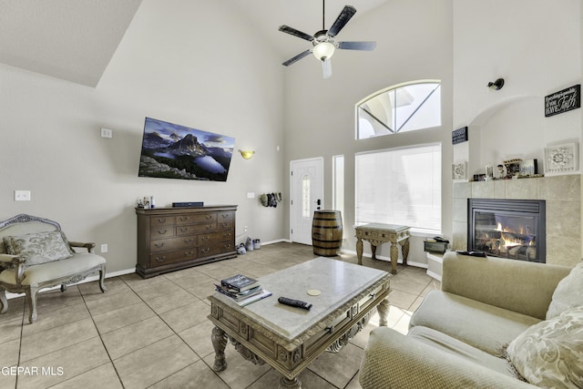 14241 Craggy Rock Ave, El Paso, TX 79938 - living room featuring high vaulted ceiling, light tile patterned floors, a ceiling fan, and a fireplace