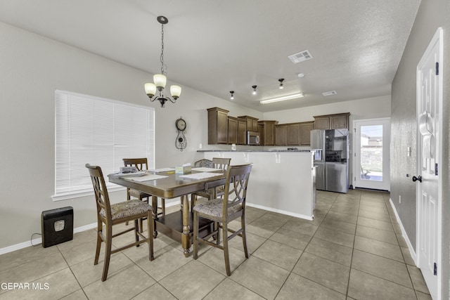 14241 Craggy Rock Ave, El Paso, TX 79938 - dining room with light tile patterned flooring, visible vents, a chandelier, and baseboards