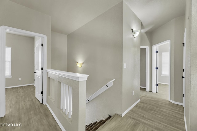 14241 Craggy Rock Ave, El Paso, TX 79938 - hall with an upstairs landing, wood finished floors, and baseboards