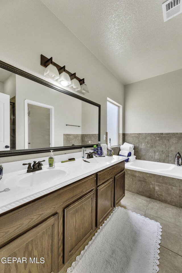 14241 Craggy Rock Ave, El Paso, TX 79938 - bathroom featuring a sink, a bath, double vanity, and visible vents