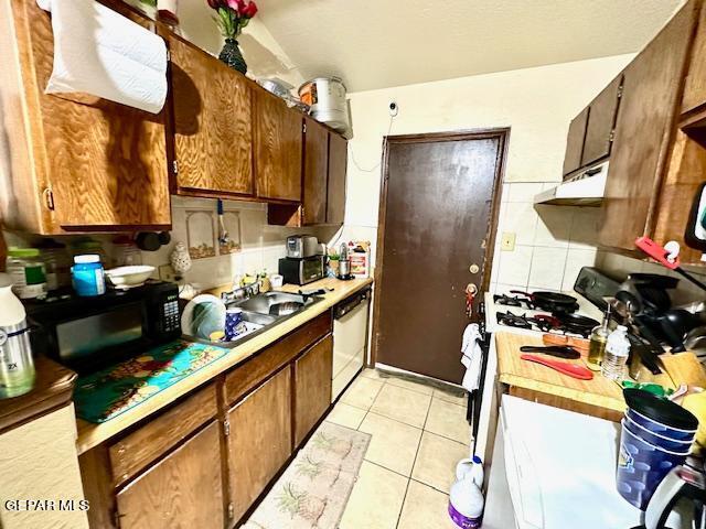 kitchen with dishwasher, white range with gas stovetop, tasteful backsplash, and light tile patterned flooring