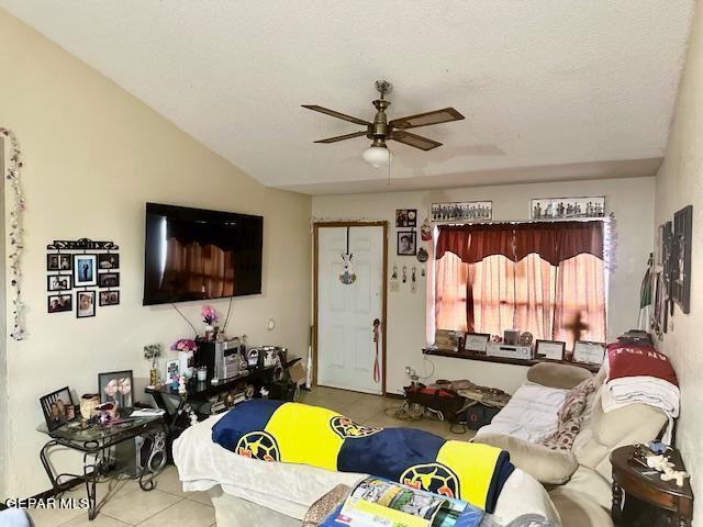 tiled living room featuring vaulted ceiling and ceiling fan